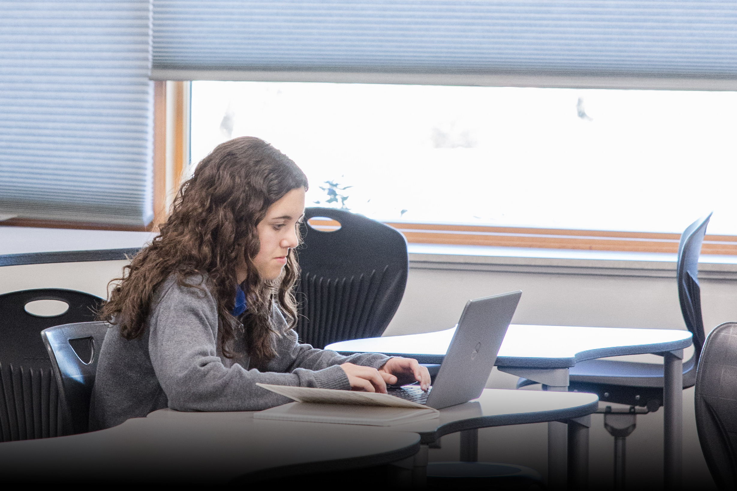 Upper School student working on computer.